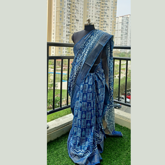 Stylist Indigo Block Print Maheshwari Silk Saree. Crafted to perfection. Complete with a matching blouse piece, this ensemble is sure to turn heads at any occasion.