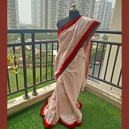 Red & White Check Pure Cotton Sari. Vibrant red hand block print border, this saree adds a pop of color and traditional charm to your ensemble. Paired with a matching blouse piece, also embellished with red hand block print and black piping