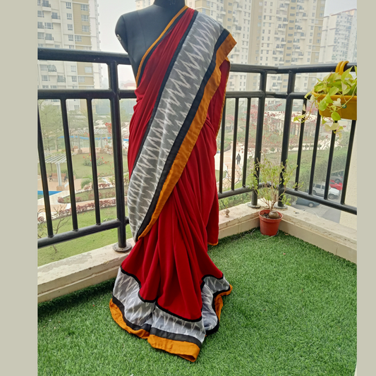 This saree features a rich maroon hue adorned with vibrant accents of mustard yellow, black, and pure grey. Paired with a matching blouse piece