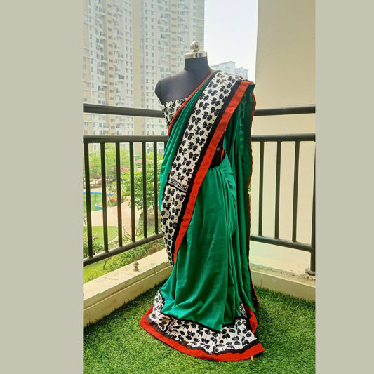 Elevate your elegance with our designer green silk saree, exquisitely crafted to enhance your grace. Complete with a matching blouse piece, this ensemble is a timeless addition to your wardrobe. - Fabcentra