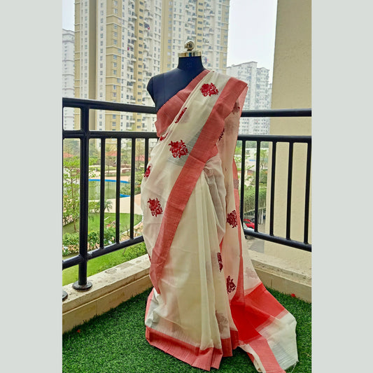 Off-white saree featuring a striking red border and intricate overall body embroidery in red buti. Complete with a contrasting blouse piece, this saree exudes elegance and charm, perfect for any special occasion. - Fabcentra