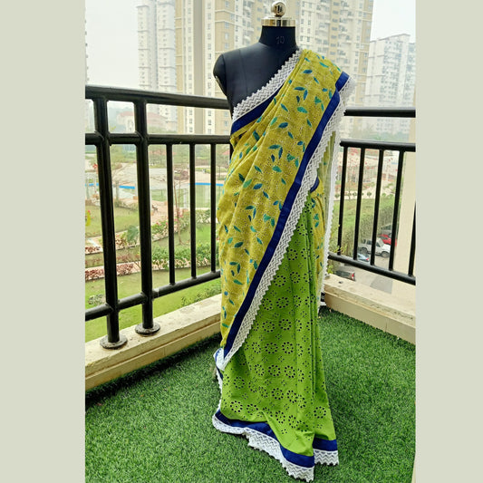 Our stunning Pure Cotton Hakoba Saree, a delightful fusion of vibrant yellow and green hues adorned with intricate hakoba embroidery. featuring a charming blue piping & white lace border - Fabcentra