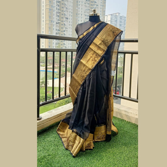 Black Organza Saree featuring a zari border and pallu with zari strips. The running blouse piece completes the ensemble