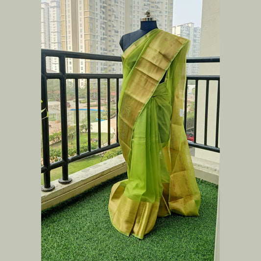 Green Organza Saree featuring a zari border and pallu adorned with jari strips. Complete with a matching running blouse piece - My Store