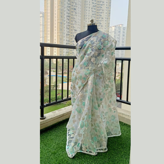 Imported Off-White Net Saree adorned with satin work design and sequin border. Paired with a white satin blouse piece for a refined ensemble. - My Store
